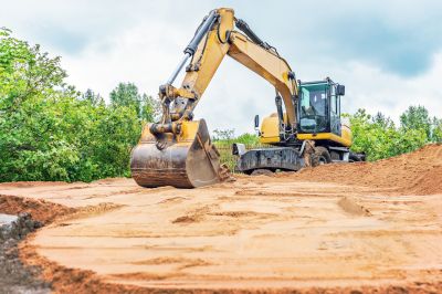 Excavator grading a yard